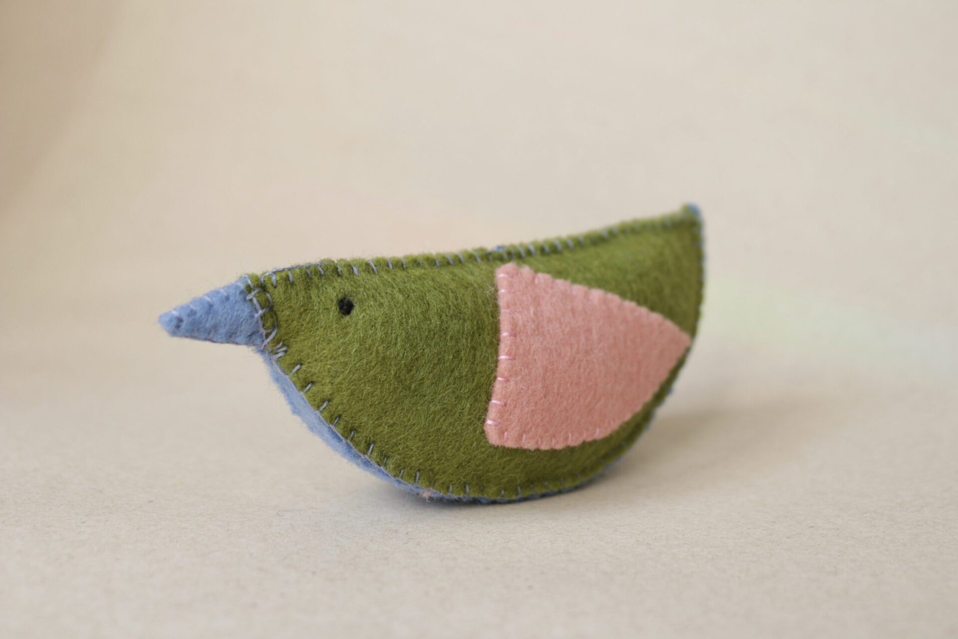 Green and pink natural wool felt bird rattle